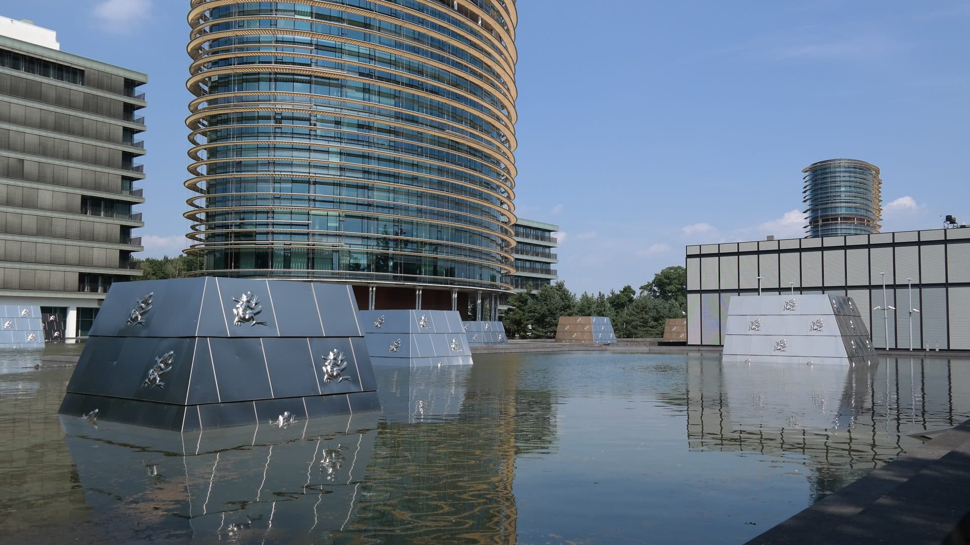 Het kantoor van de Belastingdienst in Apeldoorn, met een ronde glazen toren achter een waterpartij